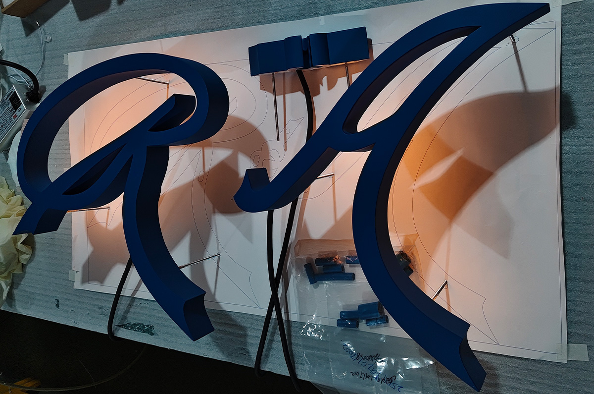 Custom backlit gym signs for a training-floor brand wall